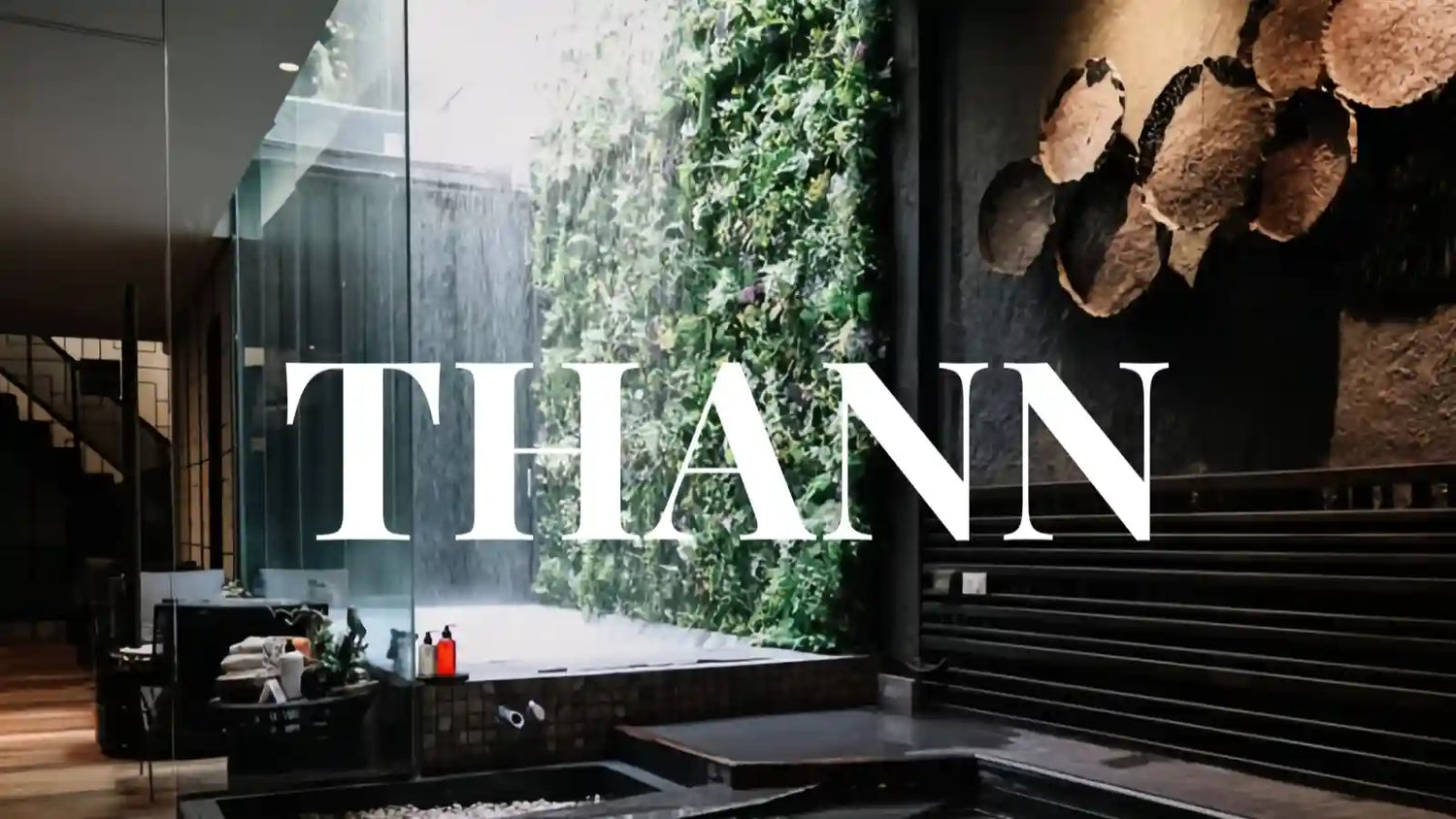 A spa bathroom with flowers and vines growing on the walls and one red Thann toiletries prominently displayed on the countertop