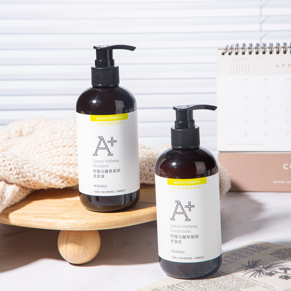 two bottles of AGRARIA hotel shampoo and conditioner displayed on the tray.