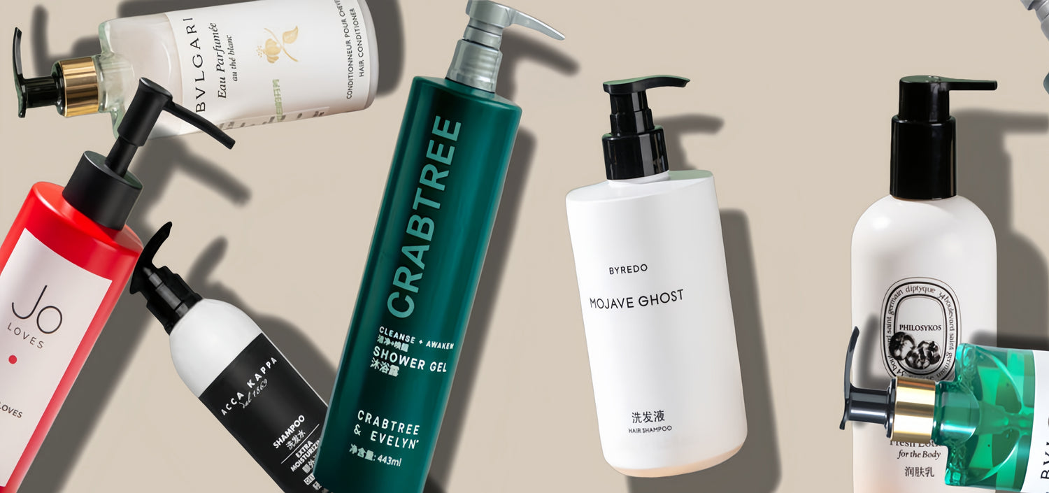 Seven bottles of hotel toiletries of different brands